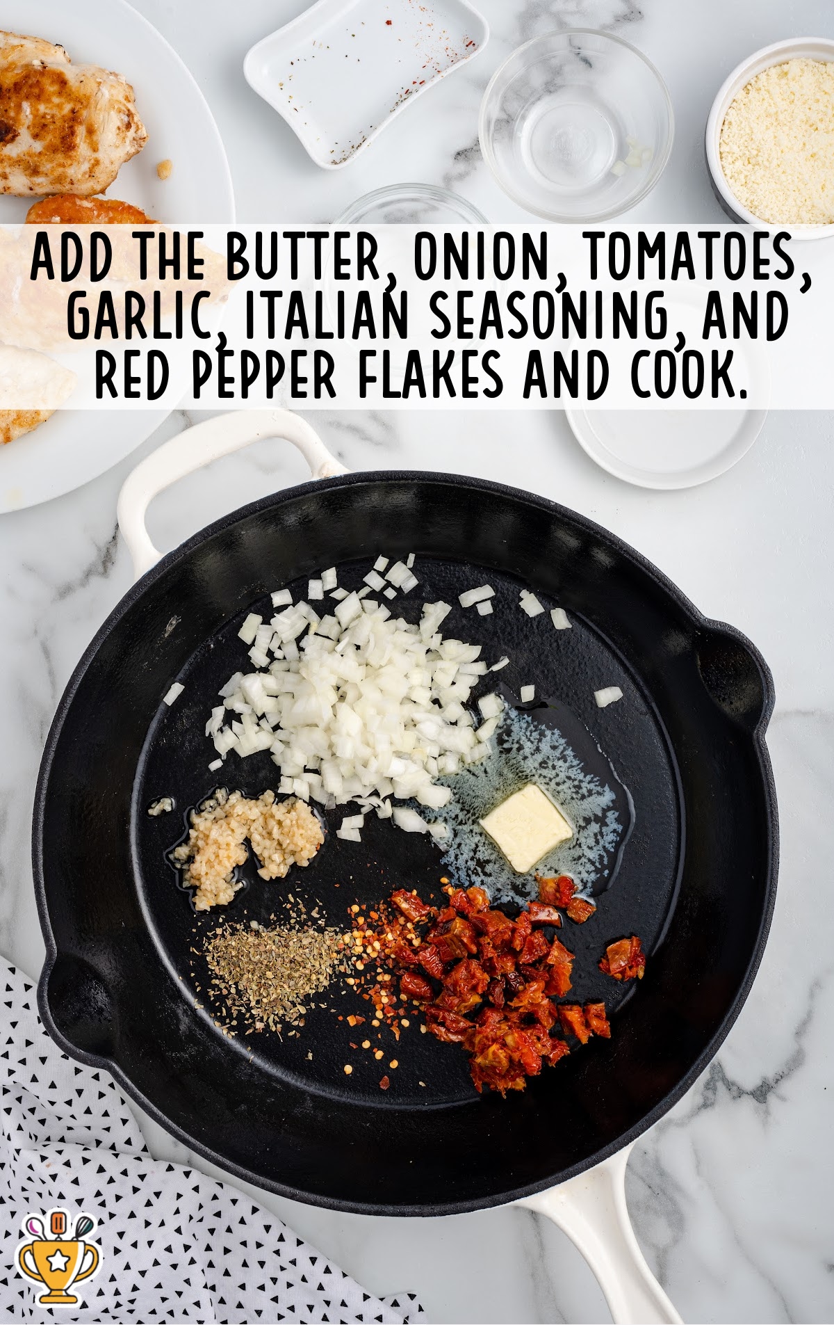 Butter, onions, garlic, sundried tomatoes, Italian seasoning, and red pepper flakes added to a skillet to sauté for sauce.