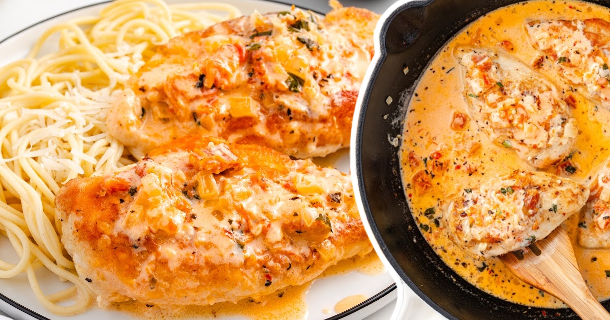 Close-up of creamy Marry Me Chicken breasts on a plate of spaghetti beside a cast iron skillet filled with sauce.