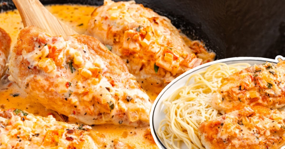 Juicy chicken breasts cooked in a creamy Parmesan tomato sauce, served with spaghetti and garnished with herbs.