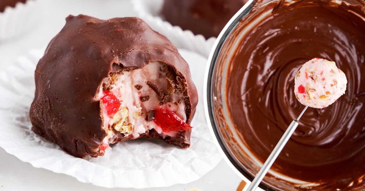 Chocolate-covered Martha Washington candy on a paper liner beside a bowl of melted chocolate, with a scoop of filling ready to dip.