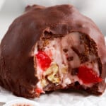 Vertical pin featuring a large Martha Washington candy in the center with the coconut-cherry filling and a small bowl of the mixture below.