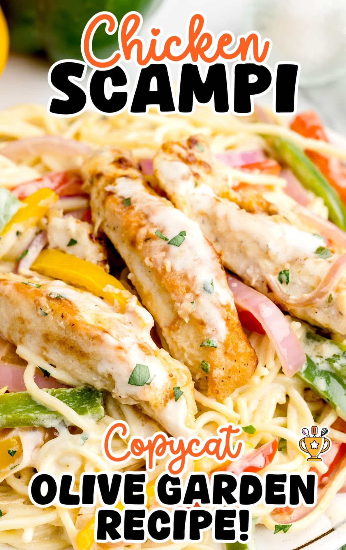 Close-up of creamy copycat Olive Garden chicken scampi with golden pan-seared chicken, colorful bell peppers, red onion, and spaghetti noodles.