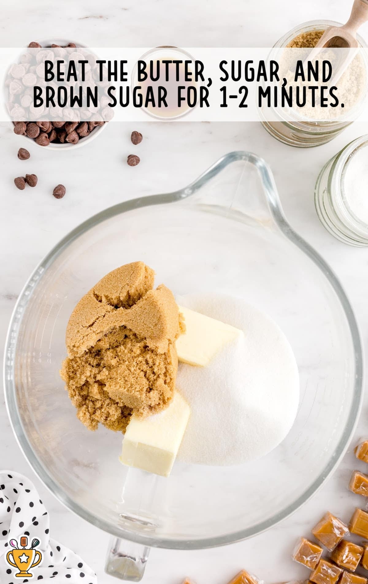 Butter, white sugar, and brown sugar in a mixing bowl ready to be beaten for the cookie dough base.