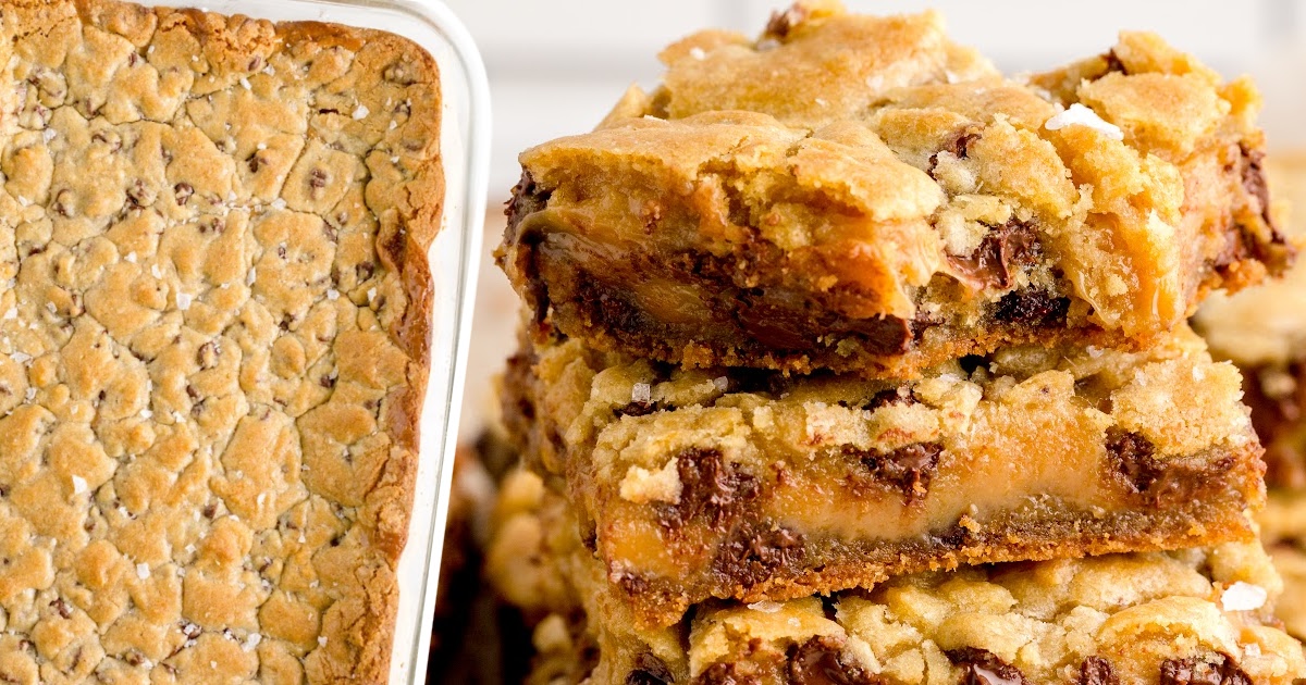 Salted caramel chocolate chip cookie bars cut into squares, with gooey caramel and melted chocolate chips visible inside each soft, chewy bar.