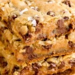 Stack of salted caramel chocolate chip cookie bars with gooey caramel and melted chocolate chips, topped with flaky sea salt.