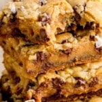 Stacked salted caramel chocolate chip cookie bars with Werther&rsquo;s Original caramels, text overlay highlighting how chewy and delicious they are.