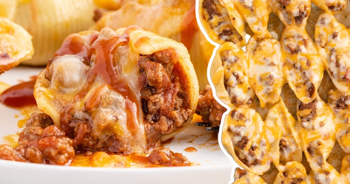 Close-up of a cheesy taco stuffed shell topped with taco sauce on a white plate, surrounded by other stuffed shells in the background.