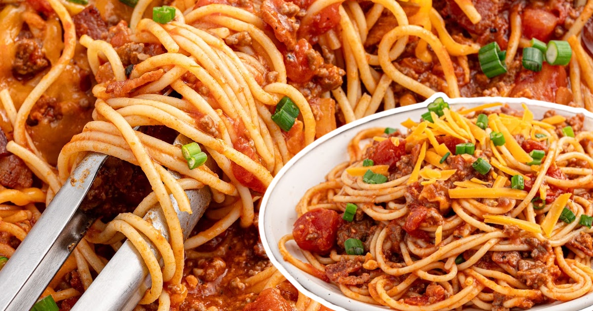 Spaghetti lifted with silver tongs from a hearty skillet, alongside a white bowl of cowboy spaghetti garnished with cheddar and green onions.