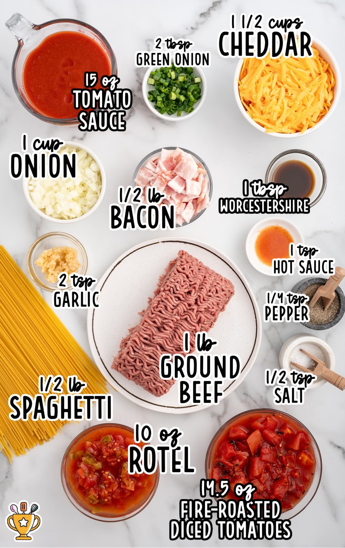 Flat lay of measured cowboy spaghetti ingredients including ground beef, bacon, spaghetti, cheese, tomatoes, garlic, onion, sauces, and spices.