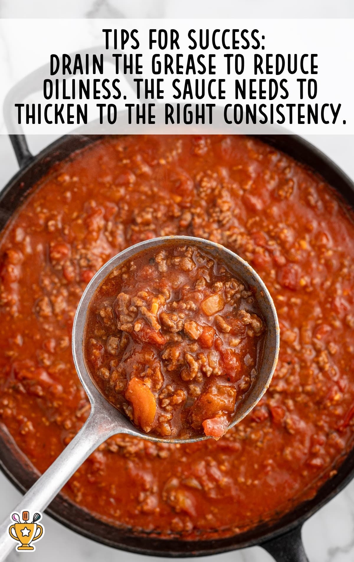 Large ladle scooping meaty tomato sauce from a skillet, with an overlay tip about draining grease and thickening the sauce.
