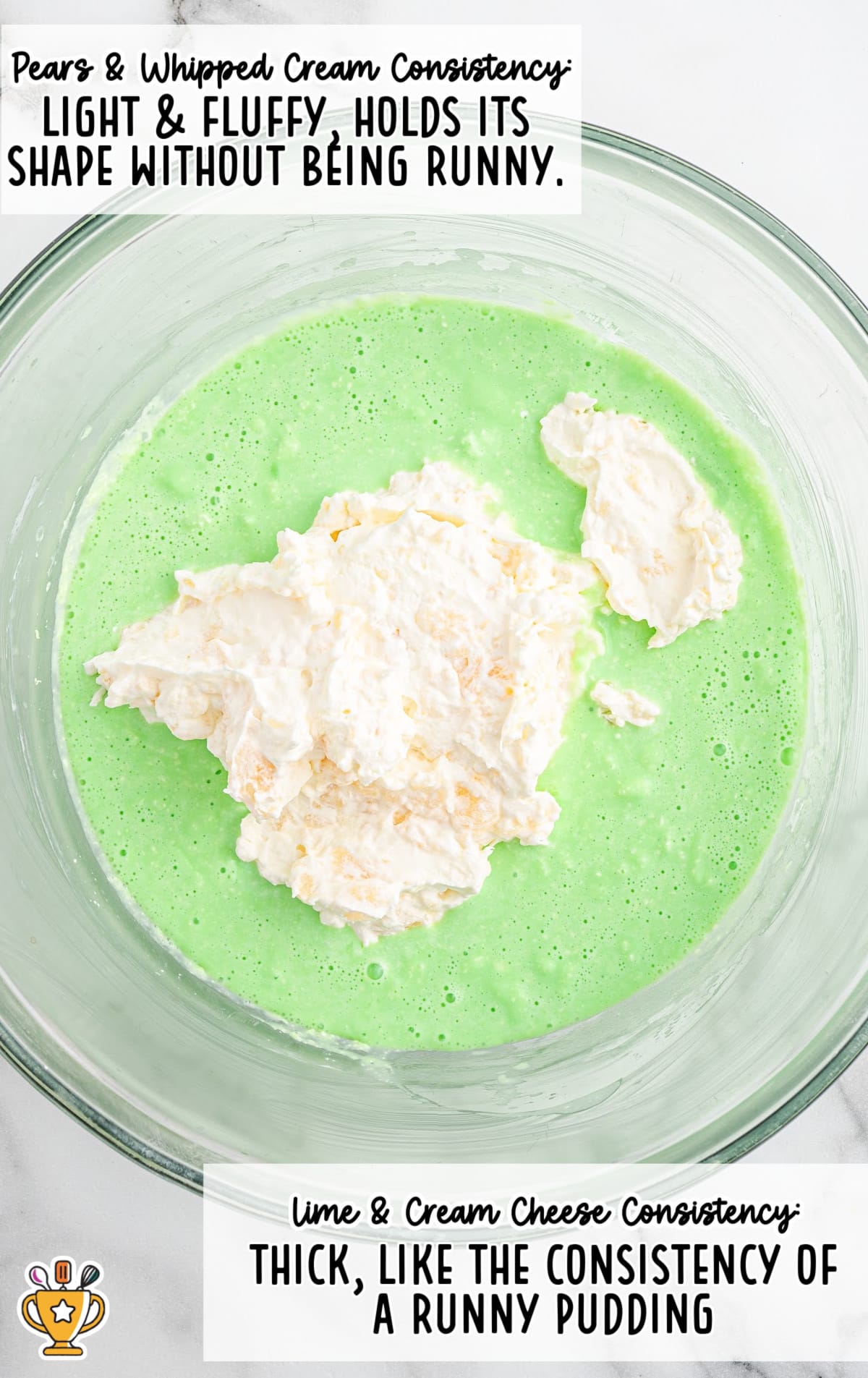 Glass mixing bowl with bright green lime and cream cheese mixture, topped with light, fluffy pears and whipped cream. Text overlay explains consistencies: pears and whipped cream should be light and fluffy, while lime and cream cheese should be thick, like runny pudding.