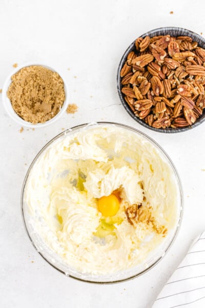 By hand, gently stir in vanilla extract and one egg at a time until fully combined.