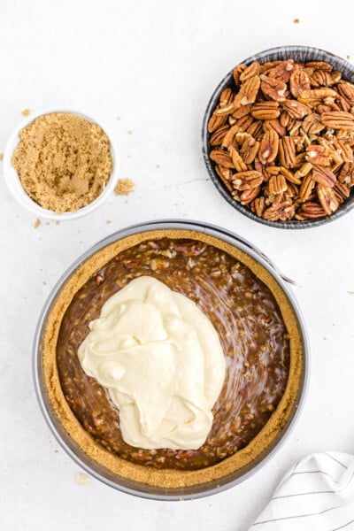Pour the cheesecake mixture evenly over the pecan filling mixture.