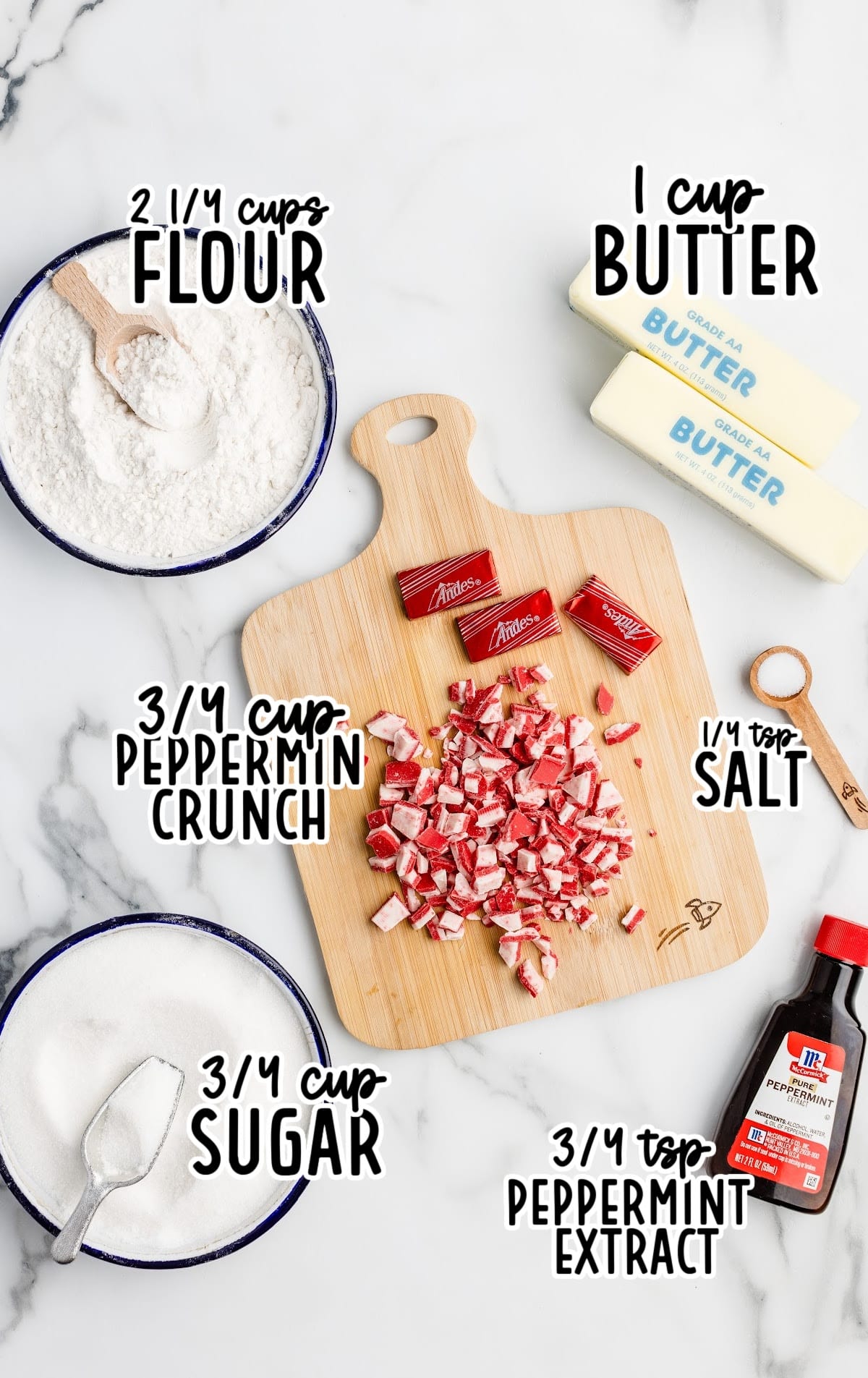 Flat lay of peppermint shortbread cookie ingredients, including bowls of flour, sugar, chopped Andes peppermint crunch, butter sticks, salt, and peppermint extract, each labeled with text overlays.