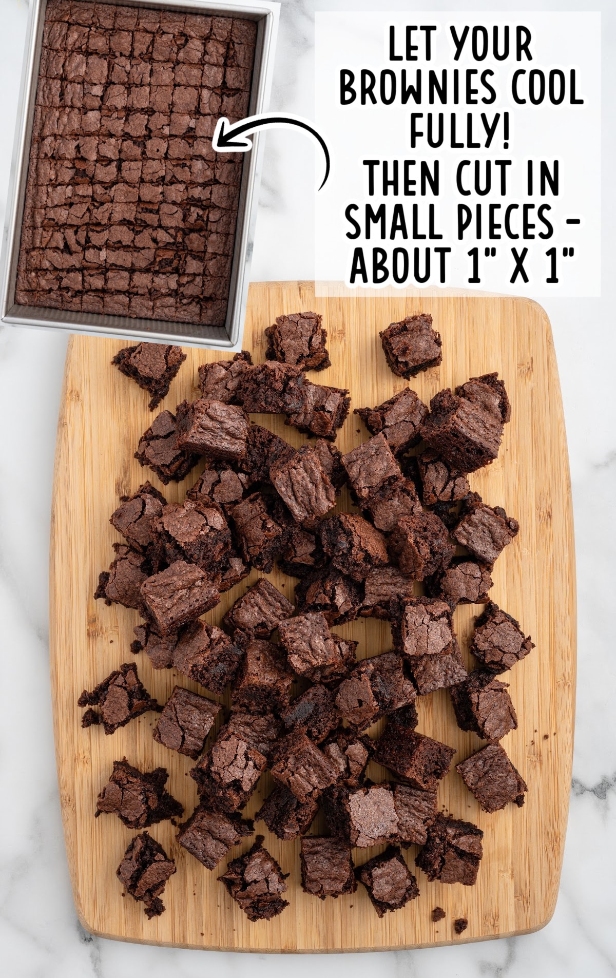Overhead view of a pan of baked brownies cut into a grid pattern and cooled, with an arrow pointing to chopped brownie squares spread on a wooden cutting board. Text overlay reads “Let your brownies cool fully! Then cut in small pieces – about 1” x 1”.”