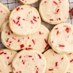 Overhead view of peppermint shortbread cookies on a cooling rack with Andes peppermint crunch candies, styled with bold text reading “cookie tray peppermint shortbread cookies” and a note about “easy gifts"
