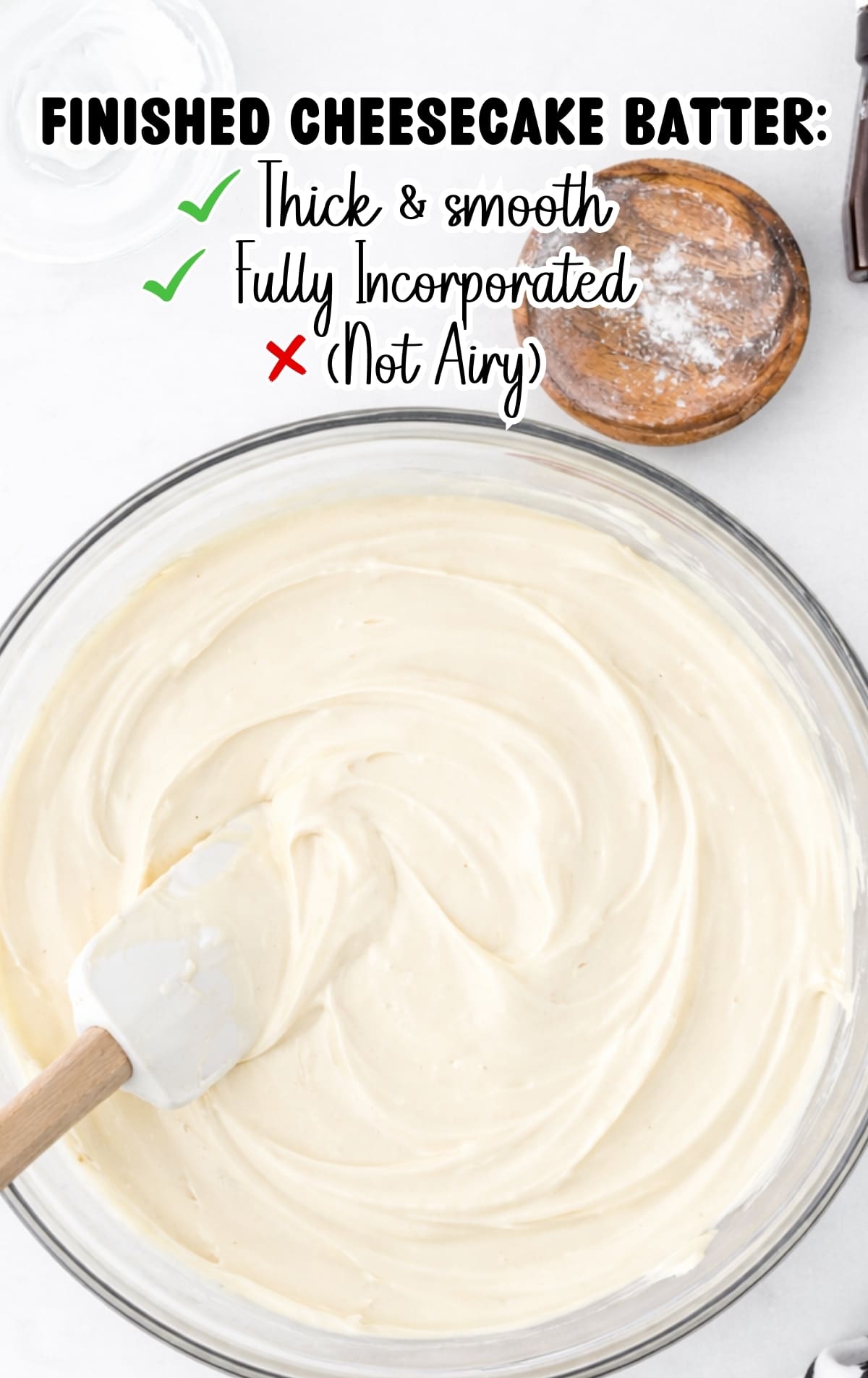 Finished cheesecake batter thick, smooth, and fully incorporated in a mixing bowl, ready to be baked