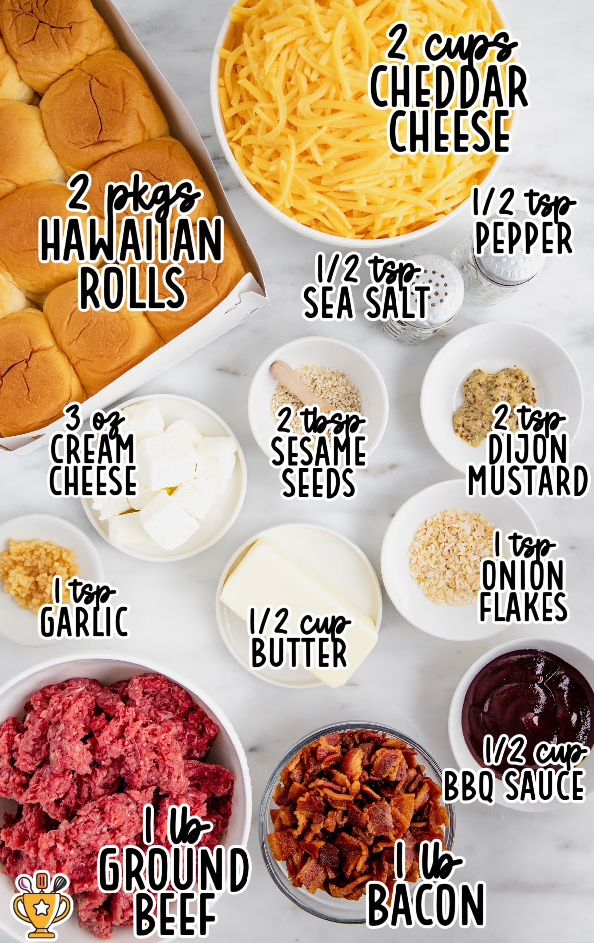 Overhead view of ingredients for bacon cheeseburger sliders including Hawaiian rolls, ground beef, bacon, cheddar cheese, butter, cream cheese, barbecue sauce, Dijon mustard, and seasonings.