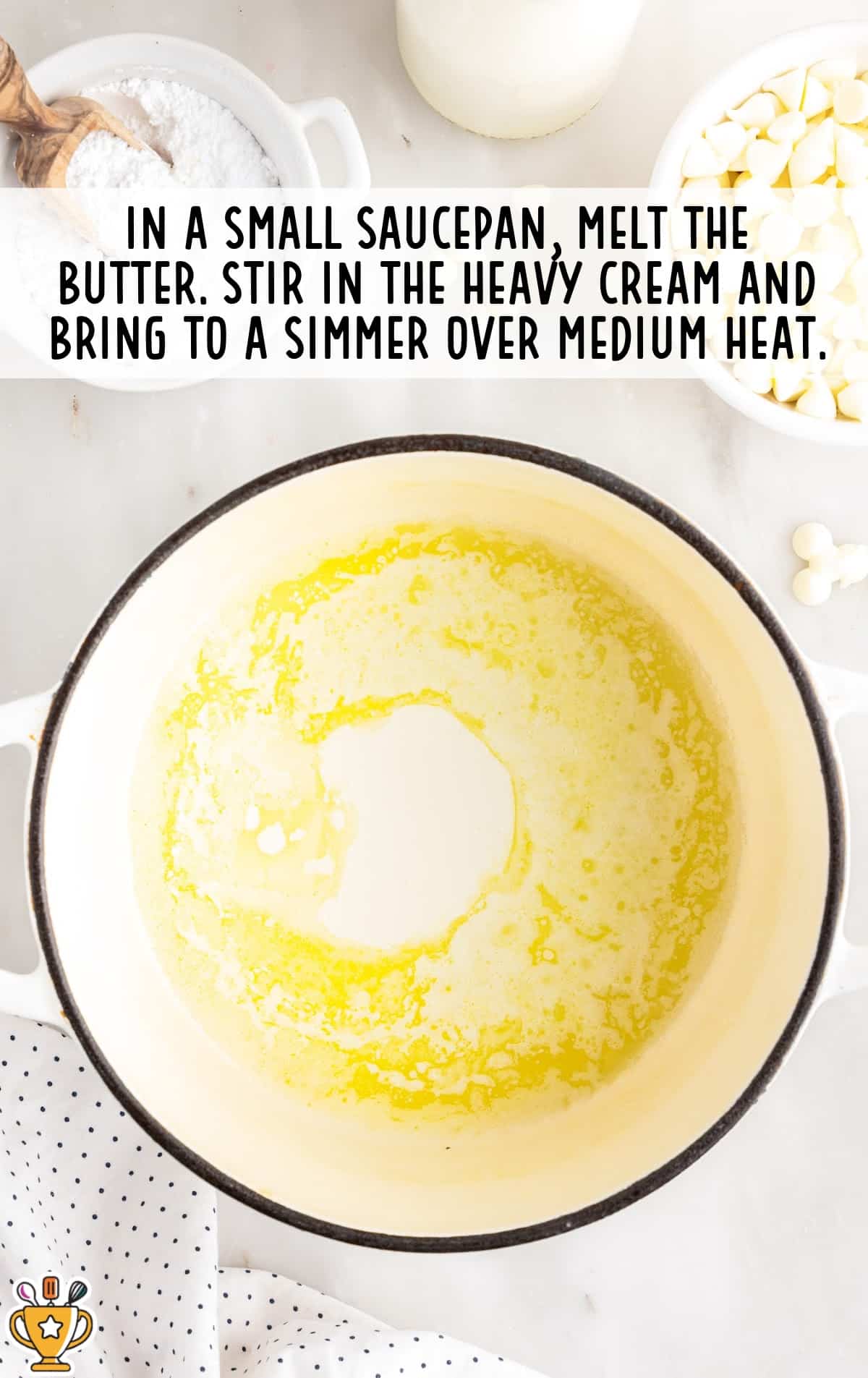 Butter and heavy cream melting together in a saucepan over medium heat, photographed from overhead as the mixture begins to warm and combine.