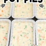 Pinterest-style image showing multiple foil pans filled with creamy chicken pot pie filling, with baked pot pies pictured at the bottom corner. On-image text reads, “Freezer Chicken Pot Pies” and “Topped with perfect flaky crust!” with Best Blog Recipes branding visible.