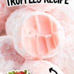 Pretty pink strawberry truffles coated in powdered sugar, stacked together with fresh strawberries beside them, highlighting the creamy white chocolate strawberry filling.
