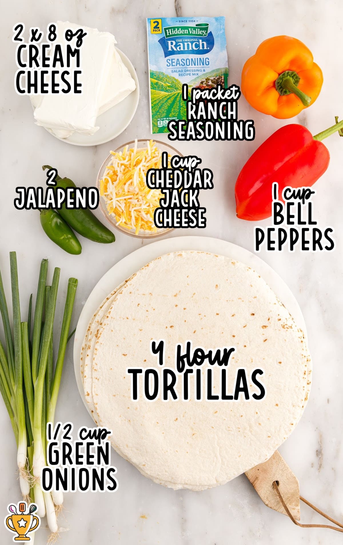 Overhead ingredient photo for ranch roll ups on a light countertop, showing cream cheese on a plate, a packet of Hidden Valley Ranch seasoning, shredded cheddar jack cheese, orange and red bell peppers, two jalapeños, green onions, and stacked flour tortillas, with text labels: “2 x 8 oz CREAM CHEESE,” “1 packet RANCH SEASONING,” “1 cup CHEDDAR JACK CHEESE,” “1 cup BELL PEPPERS,” “2 JALAPENO,” “½ cup GREEN ONIONS,” and “4 flour TORTILLAS.”