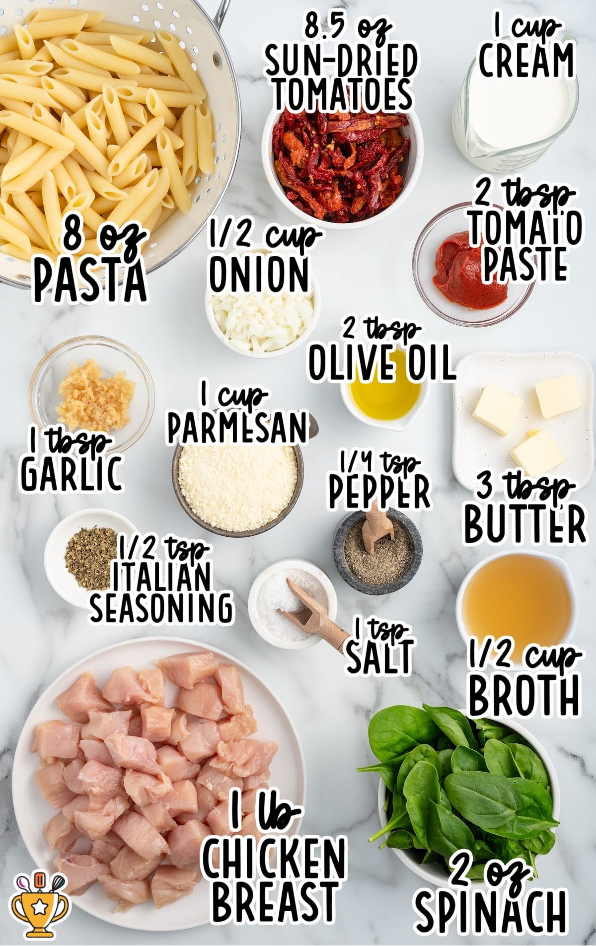 Flat lay of labeled ingredients for tuscan chicken pasta on a white countertop, including penne pasta, sun-dried tomatoes, heavy cream, tomato paste, olive oil, butter, garlic, parmesan cheese, Italian seasoning, salt, black pepper, diced chicken breast, chicken broth, onion, and fresh spinach, with text identifying each ingredient and measurement.