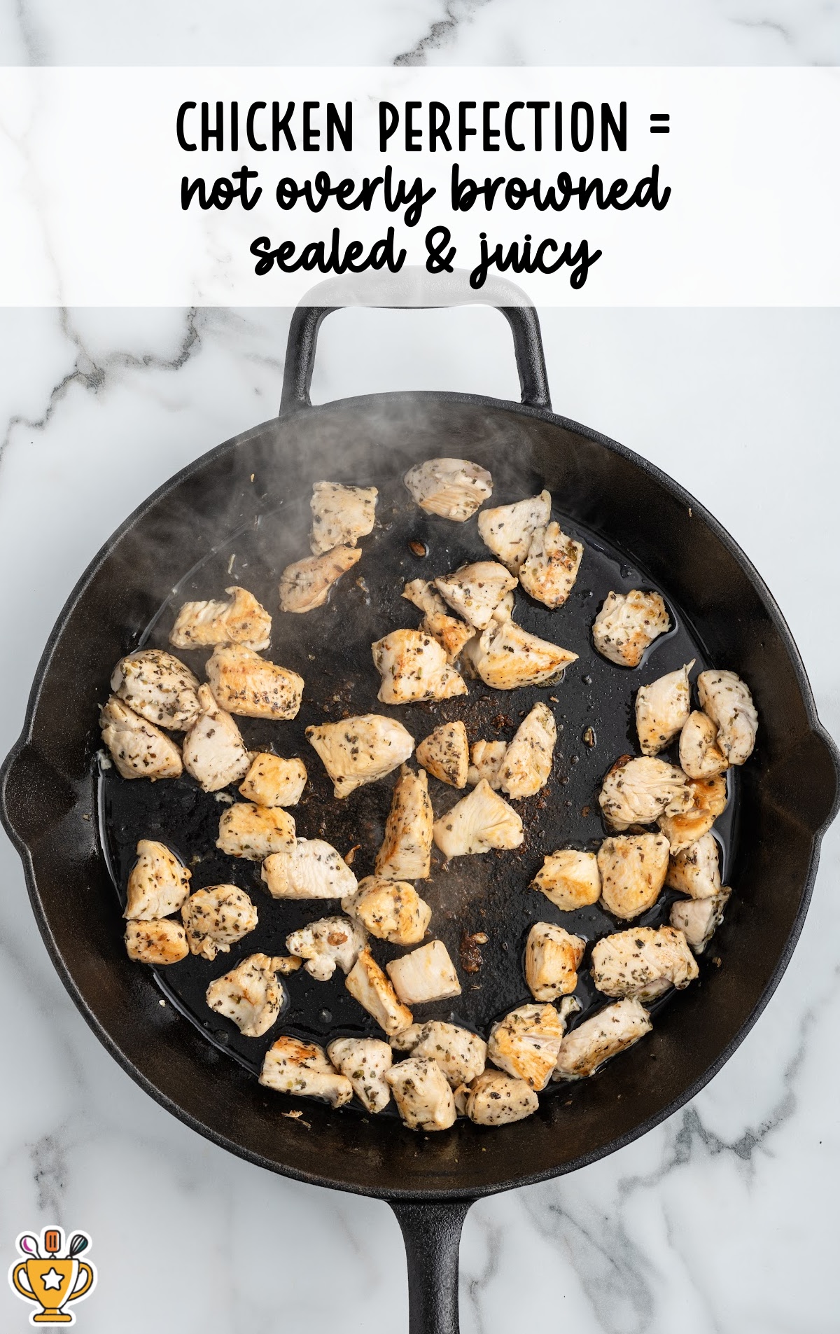 Diced chicken breast cooking in a skillet, lightly golden and sealed on the outside but not overly browned, showing the correct doneness before adding it back to the Tuscan chicken pasta.