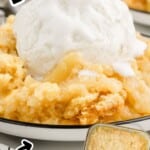 Vertical Pinterest image of Pineapple Dump Cake with a large scoop of vanilla ice cream melting over golden pineapple filling and buttery crumble topping. Text on image reads: “PINEAPPLE DUMP CAKE” and “with EASY CRUMBLE TOPPING.” A small baking dish of the cake appears in the corner with “Best Blog Recipes” logo.