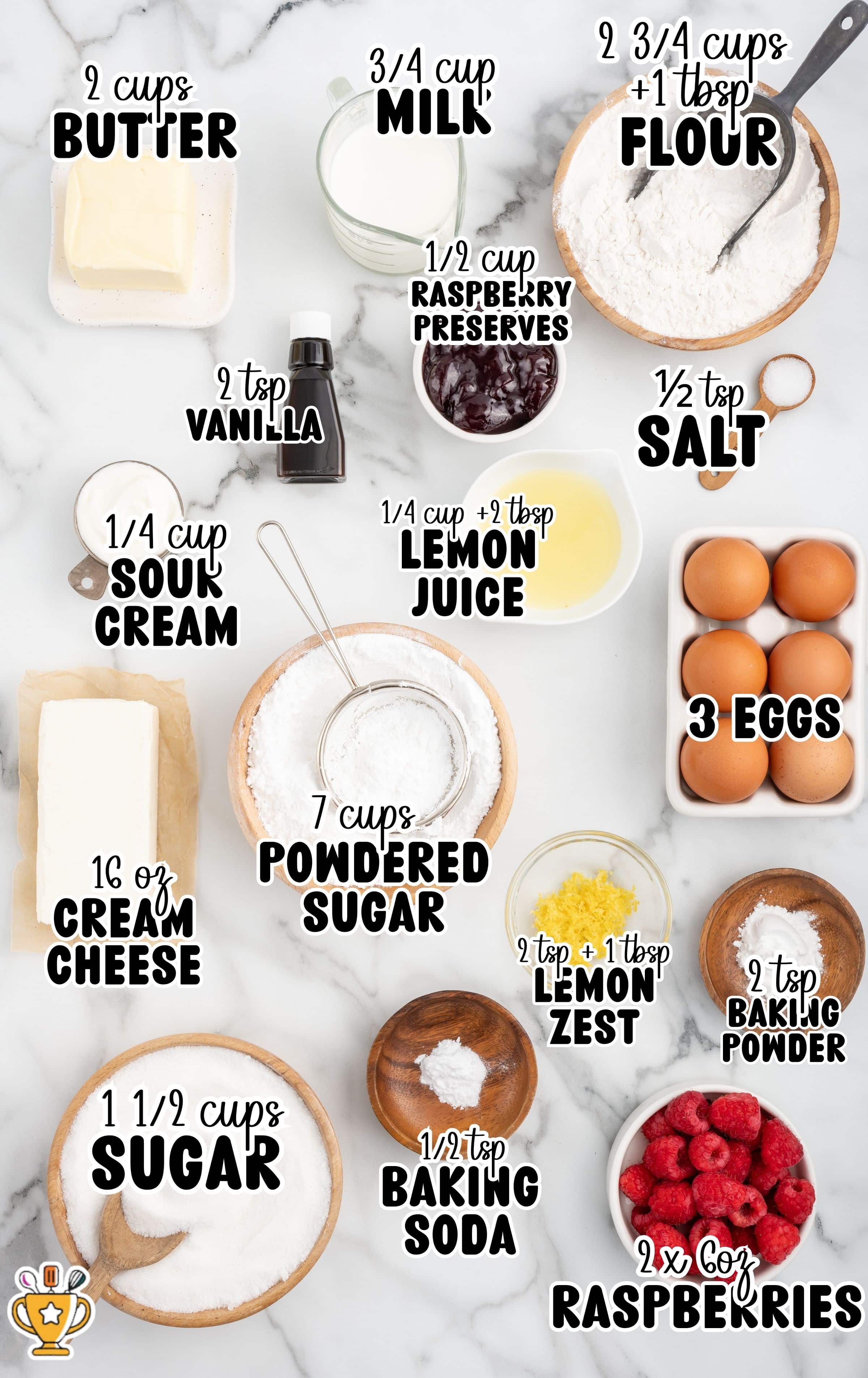 Overhead view of ingredients for Lemon Raspberry Cake labeled with measurements: 2 cups butter, ¾ cup milk, 2 ¾ cups + 1 tbsp flour, ½ tsp salt, 3 eggs, 2 tsp vanilla, ¼ cup sour cream, ¼ cup + 2 tbsp lemon juice, 7 cups powdered sugar, 2 tsp + 1 tbsp lemon zest, 2 tsp baking powder, 1 ½ cups sugar, ½ tsp baking soda, 16 oz cream cheese, ½ cup raspberry preserves, and 2 x 6 oz raspberries.
