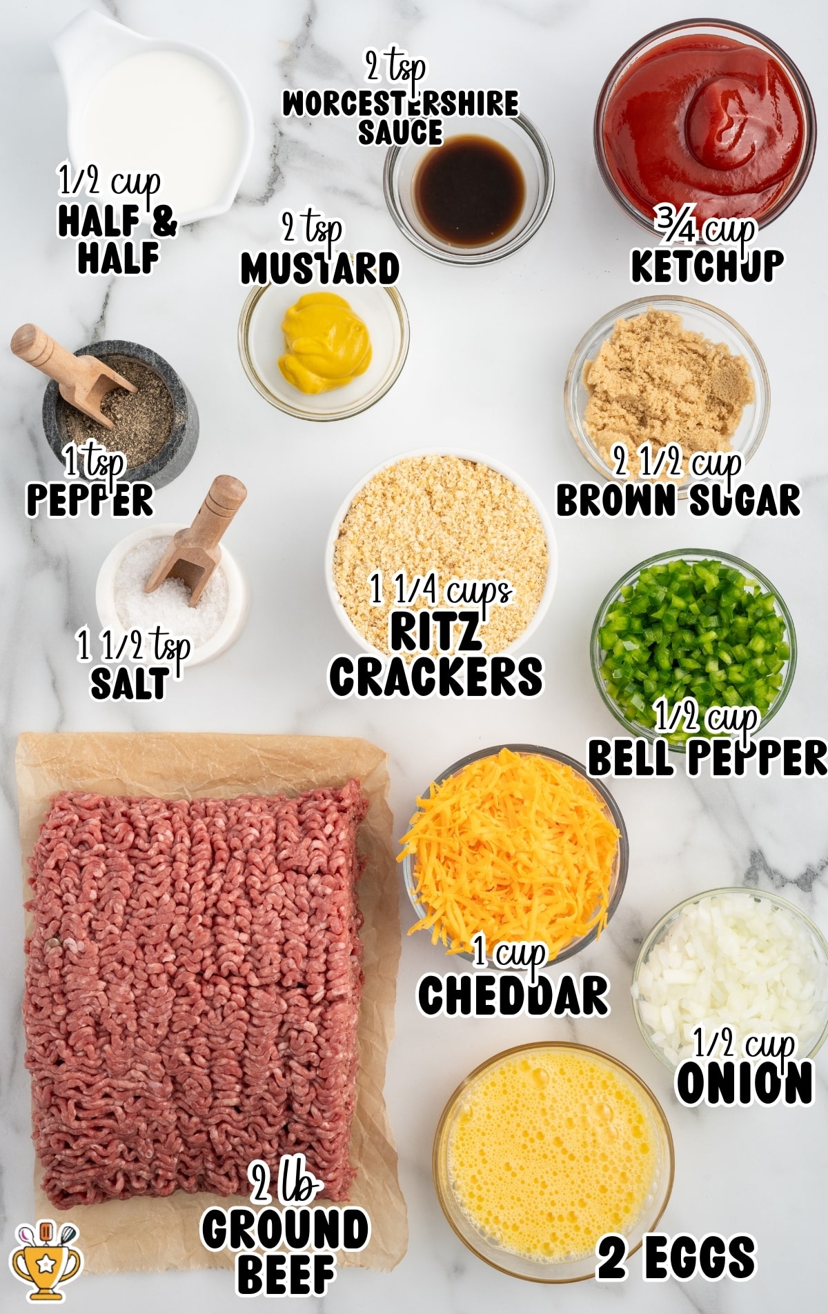 Overhead flat lay of Cracker Barrel meatloaf ingredients arranged on a white marble surface, each labeled with text. Ingredients include raw ground beef on parchment paper, crushed Ritz crackers in a bowl, shredded cheddar cheese, chopped green bell pepper, diced onion, beaten eggs, half and half, ketchup, brown sugar, yellow mustard, Worcestershire sauce, kosher salt, and black pepper.