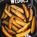 Air fryer basket filled with golden potato wedges sprinkled with parsley, with a small corner photo of wedges on checkered paper. Text on image: &ldquo;POTATO WEDGES&rdquo; and &ldquo;EASY IN THE AIR FRYER!&rdquo;