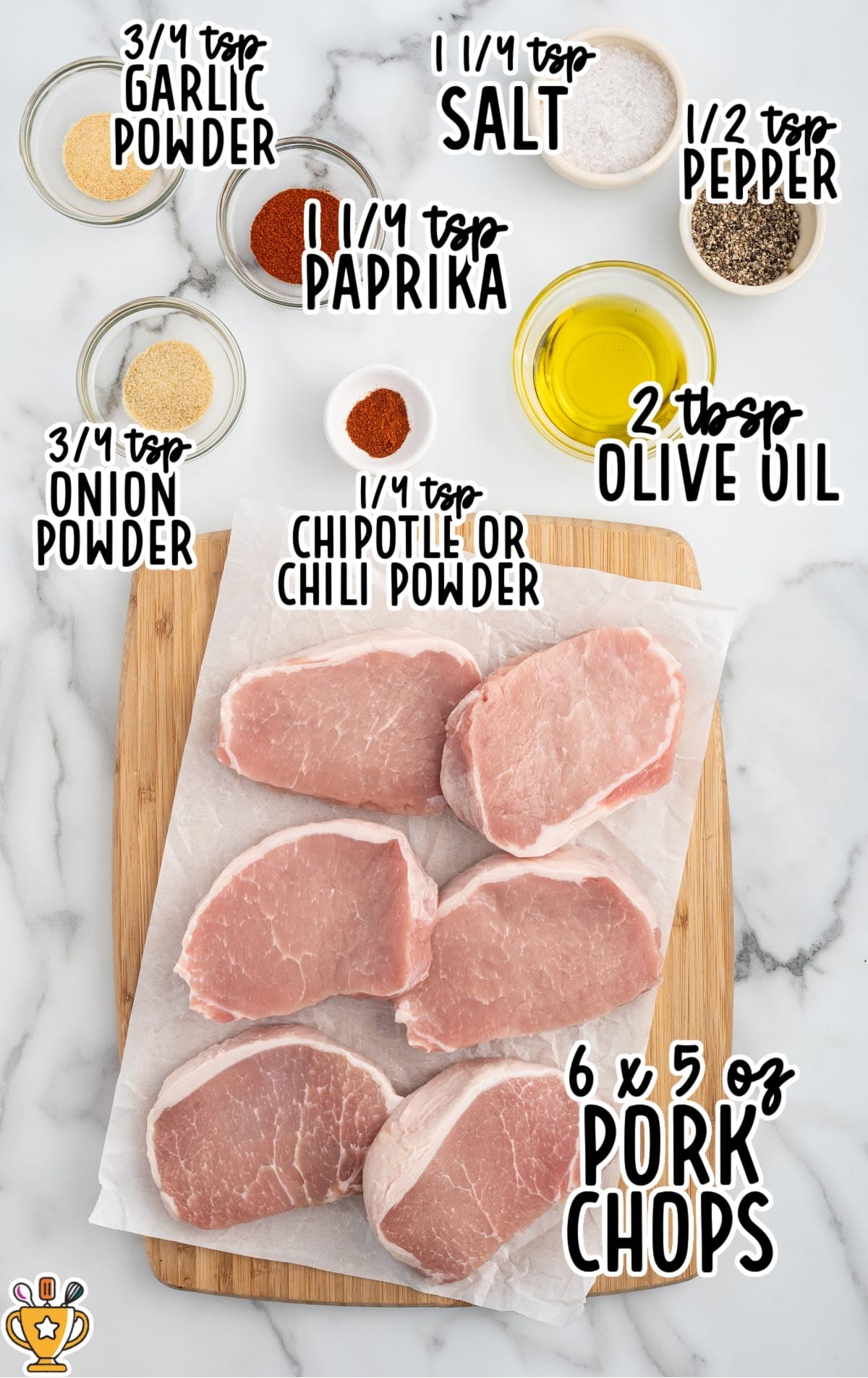 Raw boneless pork chops arranged on parchment paper with labeled ingredients for boneless pork chops in air fryer: “¾ tsp garlic powder,” “¾ tsp onion powder,” “1 ¼ tsp paprika,” “¼ tsp chipotle or chili powder,” “1 ¼ tsp salt,” “½ tsp pepper,” “2 tbsp olive oil,” and “6 x 5 oz pork chops.”