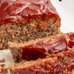 Copycat Cracker Barrel meatloaf sliced on a plate with a classic savory ketchup glaze.