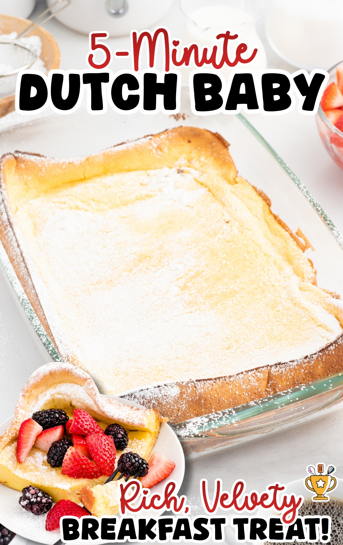 Vertical graphic of a dutch baby baked in a glass dish and coated with powdered sugar, with a plated berry-topped slice in the corner; text on image reads &ldquo;5-minute DUTCH BABY&rdquo; and &ldquo;Rich, Velvety Breakfast Treat&rdquo;