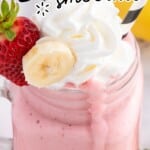 Close-up of a creamy strawberry banana smoothie in a glass mason jar mug with whipped cream on top, a fresh strawberry and banana slice garnish, and a black-and-white striped straw, with a smoothie drip running down the side; text overlay says “STRAWBERRY BANANA smoothie” and “ready in just 5 minutes!” with a “Best Blog Recipes” logo.