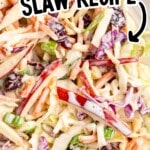 Pinterest graphic showing a close-up of creamy Apple Slaw with cabbage, apples, carrots, cranberries, and green onions. On-image text says “APPLE SLAW RECIPE” and “SOOO SWEET & CREAMY!!”