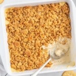Ritz Cracker Chicken Casserole baked in a white casserole dish with a creamy chicken filling and a golden buttery Ritz cracker topping.