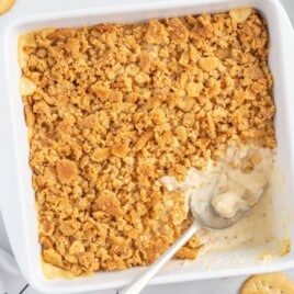 Ritz Cracker Chicken Casserole baked in a white casserole dish with a creamy chicken filling and a golden buttery Ritz cracker topping.