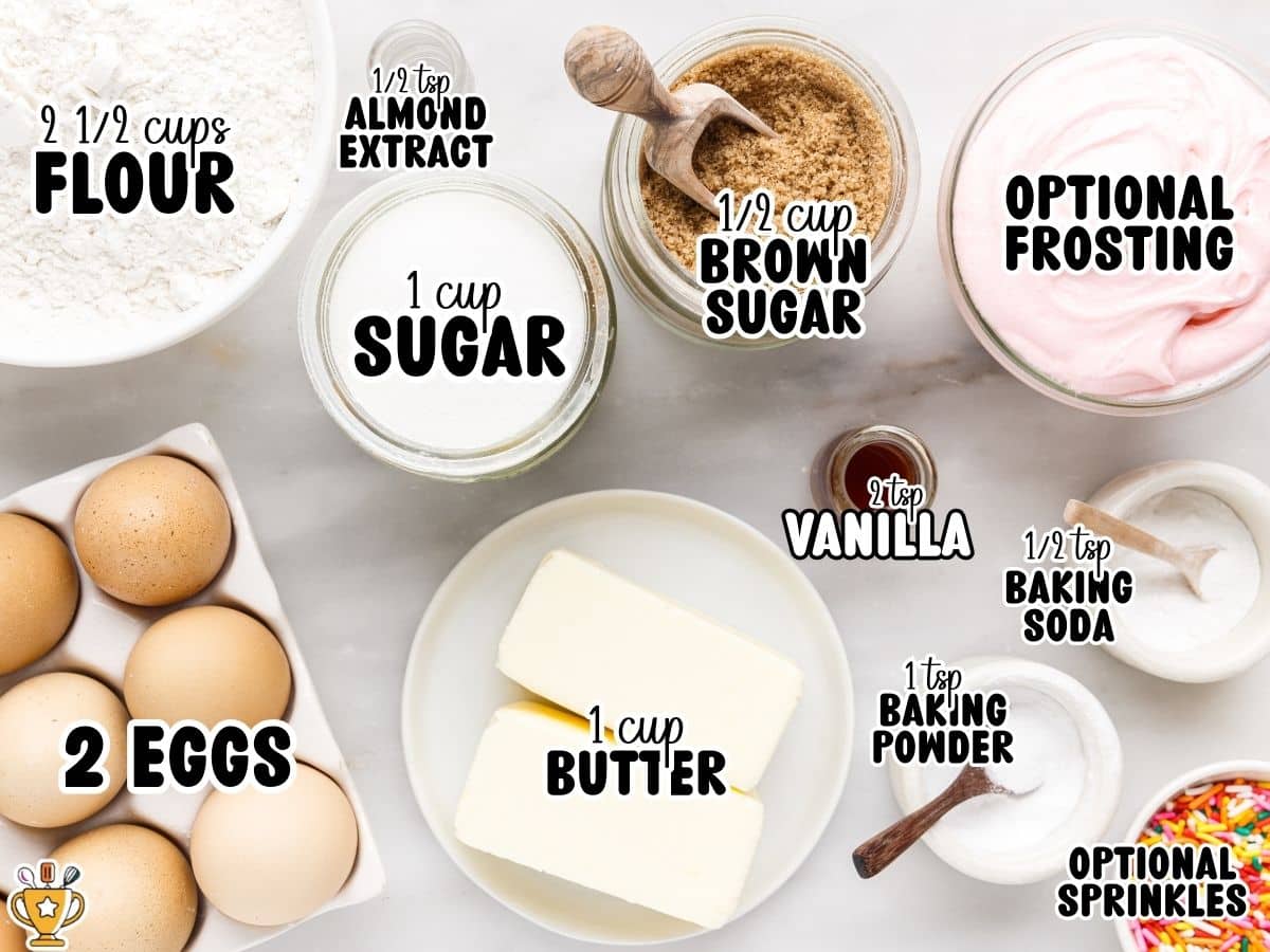 Overhead ingredients photo for Softest Sugar Cookies with text labels: “2 EGGS,” “2 ½ cups FLOUR,” “1 cup SUGAR,” “1 cup BUTTER,” “½ cup BROWN SUGAR,” “1 tsp BAKING POWDER,” “½ tsp BAKING SODA,” “2 tsp VANILLA,” “½ tsp ALMOND EXTRACT,” plus “OPTIONAL FROSTING” and “OPTIONAL SPRINKLES.”