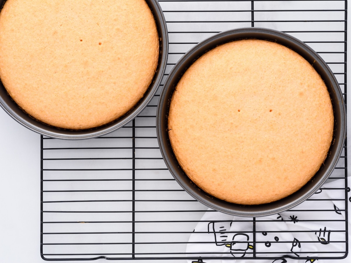 Orange soda cake layers cooling in round pans on a wire rack with lightly golden tops and an even rise.
That’s clean, professional, and fully aligned with Google’s intent.