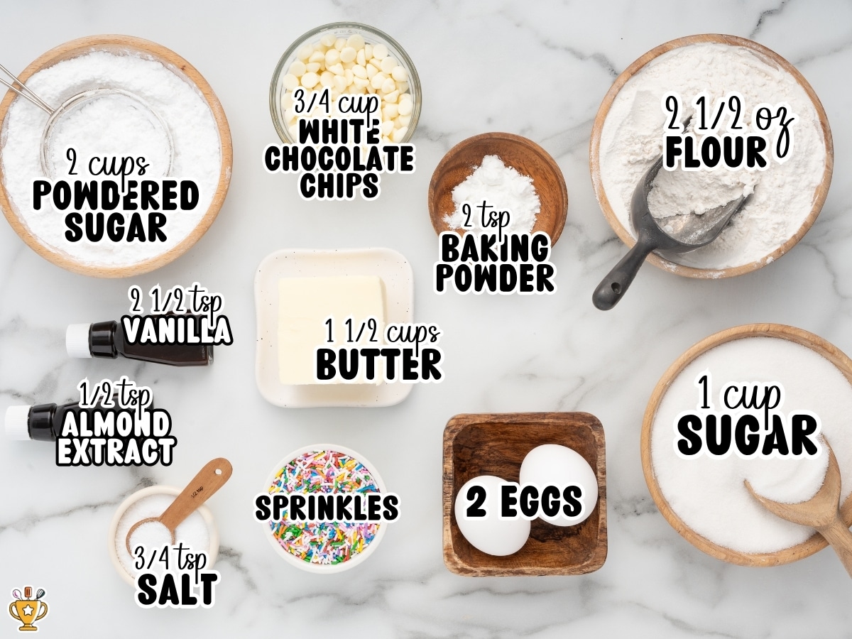 Ingredients for Birthday Cake Cookies labeled with text: 2 cups powdered sugar, ¾ cup white chocolate chips, 2 tsp baking powder, 2 ½ oz flour, 2 ½ tsp vanilla, ½ tsp almond extract, ¾ tsp salt, sprinkles, 1 ½ cups butter, 2 eggs, and 1 cup sugar.