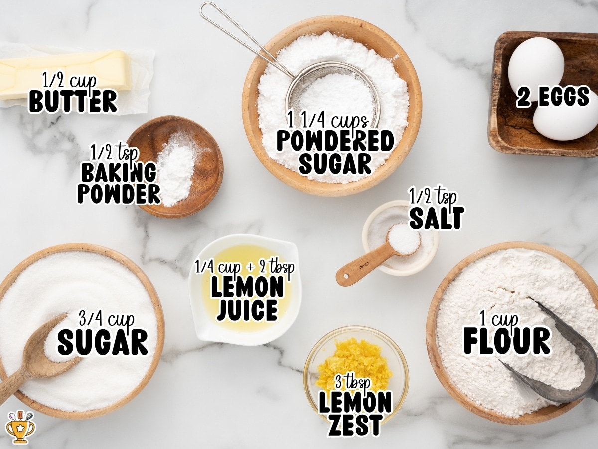 Overhead view of ingredients for lemon blondies on a marble background, showing butter, powdered sugar, eggs, baking powder, sugar, lemon juice, lemon zest, salt, and flour with labeled text