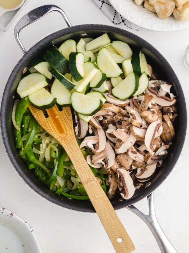 Zucchini and mushrooms added to the skillet with onions and green pepper.