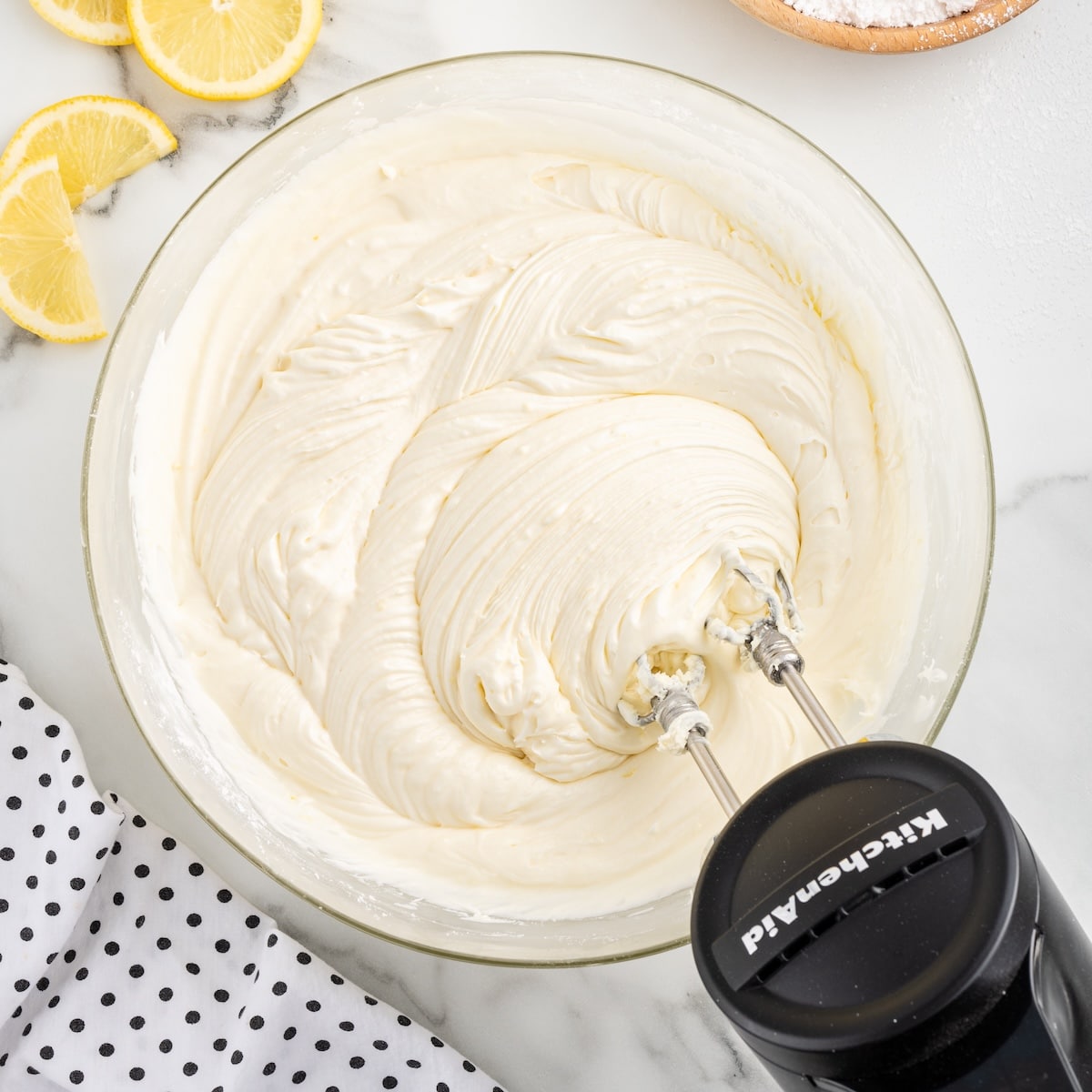 Finished lemon cream cheese frosting beaten until smooth and fluffy in a glass bowl with a hand mixer.