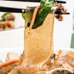 Pinterest graphic for Korean noodles with chopsticks lifting Korean glass noodles and text overlay reading “Korean noodles” and “so much better than takeout!”