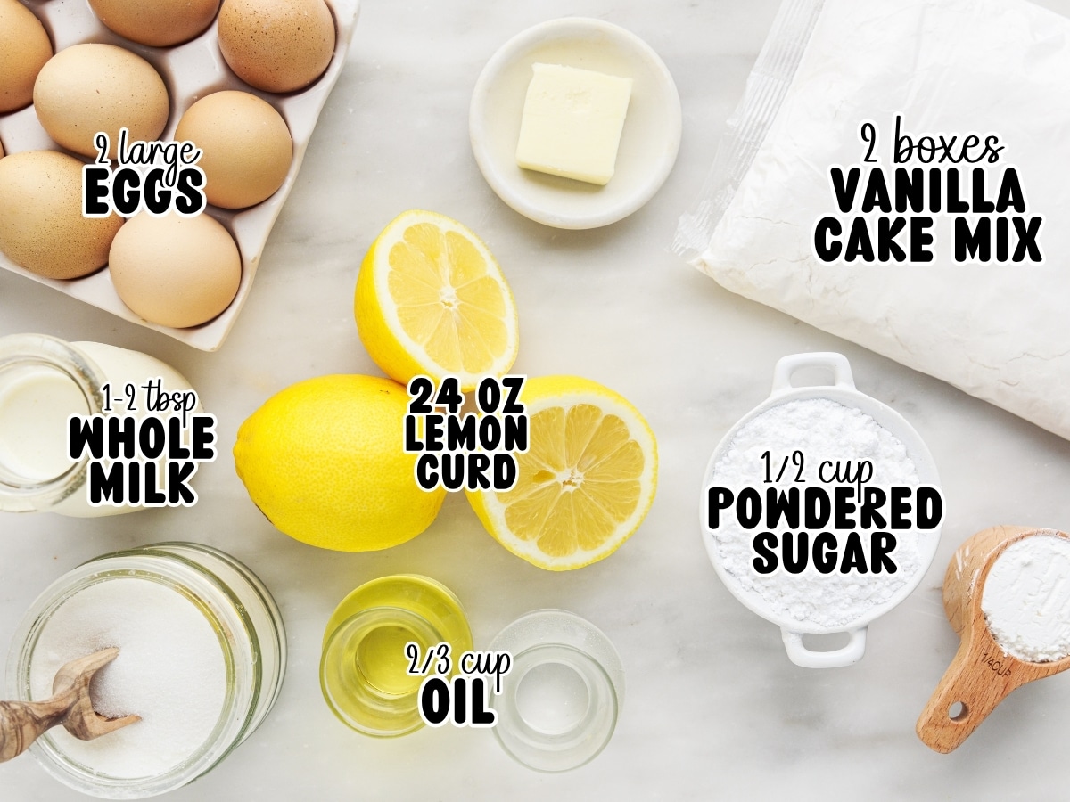 Ingredient photo for lemon pie bars showing labeled vanilla cake mix, eggs, lemon curd, oil, whole milk, powdered sugar, and fresh lemons arranged on a marble surface.