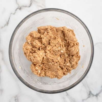 Bacon dog treat dough with oats mixed together in a glass bowl