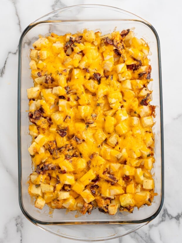 Mississippi mud potatoes fully baked with a layer of melted cheddar cheese covering the top of the dish