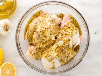 oven baked chicken thighs marinating in lemon Dijon sauce before baking